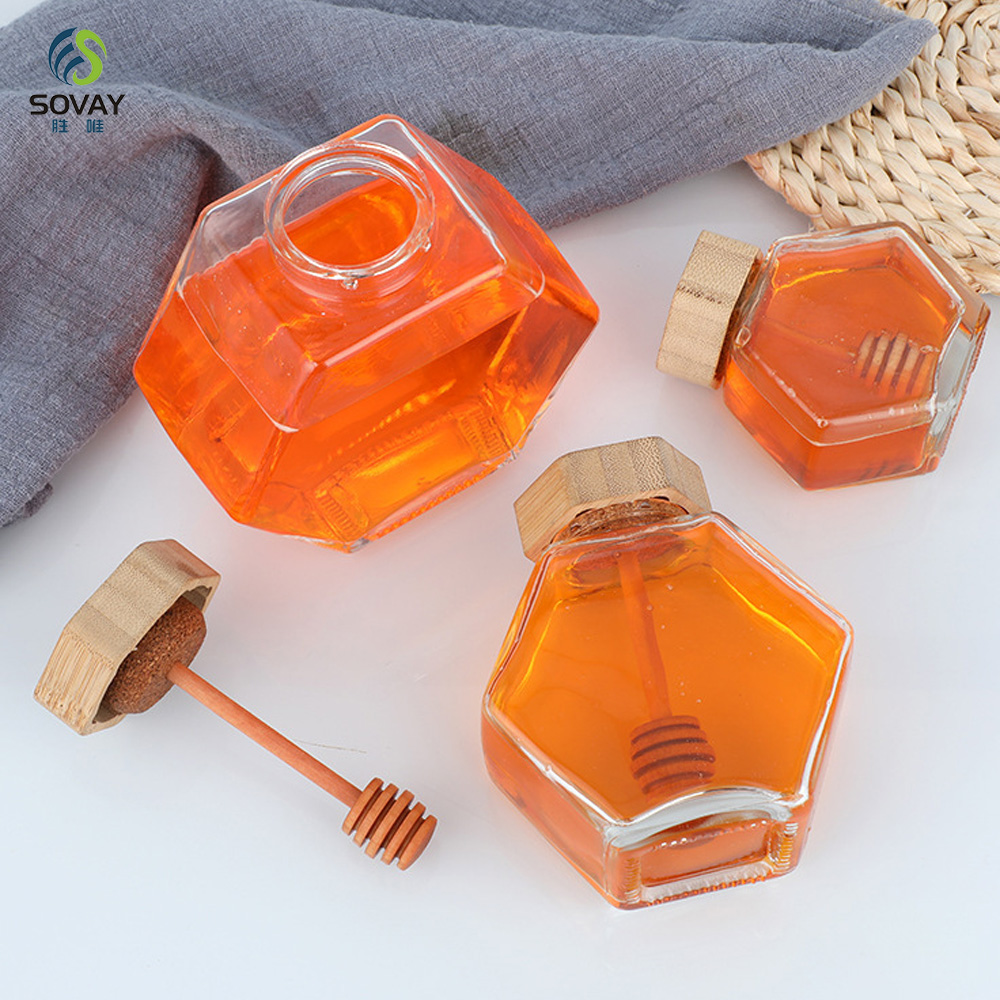 SG10N Wholesale Honey Jar Glass Hexagon Shape Honey Jar Glass with Wooden Dipper and Cork Lid Cover Honey Syrup Storage